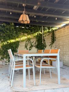 a white table and chairs on a patio at Apartamenty Gliwicka 12 