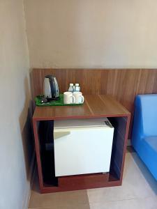 a table with two mugs on top of it at Baiduri's Place in Pantai Cenang