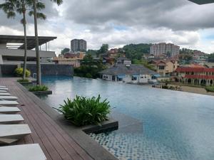 a large swimming pool with a city in the background at Homestay MKH Boulevard 1 in Kajang