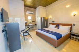 a bedroom with a bed and a chair in a room at W H Nest Hostel in Cochin