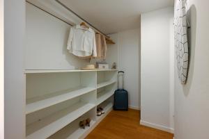 a walk in closet with white shelves at La Tana di Alice in Muggia