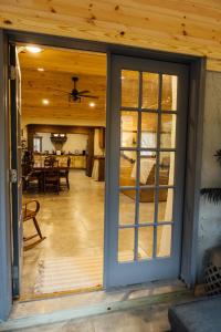 a sliding glass door of a house with a dining room at Escape to Villa Serena in Dahlonega