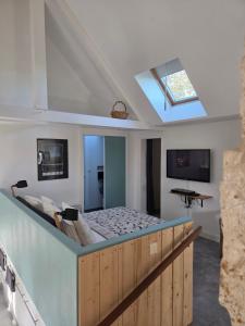 Angles-sur-lʼAnglin里格内住宿加早餐旅馆的一张位于带天窗的客房内的大床