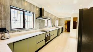 een grote keuken met een wastafel en een fornuis bij Melodia V in Durban