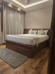 a bedroom with a large bed with white sheets and pillows at Pratima Heritage in Bhubaneshwar +15 photos