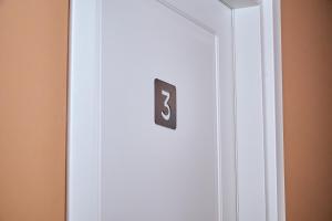 eine weiße Tür mit der Nummer sechs darauf in der Unterkunft Guest House Aura - Lumys Fiumicino in Fiumicino