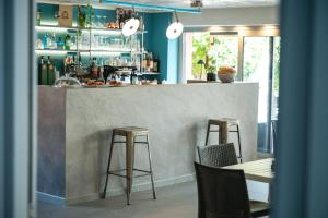 a bar with two stools and a counter at Perla Marina Apartments in Pietra Ligure