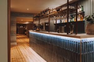 a bar in a restaurant with a wooden floor at The Old Quay House Hotel in Fowey