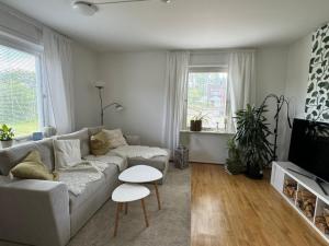 a living room with a couch and a tv at Emil hemma in Järnforsen