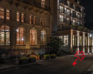 巴登-巴登Maison Messmer - ein Mitglied der Hommage Luxury Hotels Collection的前面有红色弓的大建筑