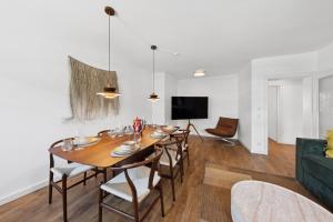 a dining room with a large wooden table and chairs at Casa Tantris zentral und modern mitten in Gmund in Gmund am Tegernsee