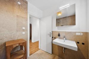 a bathroom with a sink and a mirror at Casa Tantris zentral und modern mitten in Gmund in Gmund am Tegernsee +33 photos
