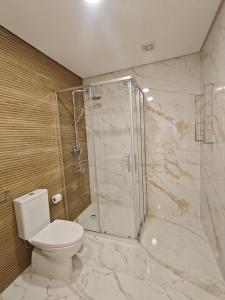 a bathroom with a shower and a toilet in it at Refugio do Surf Cortegaça in Cortegaça +19 photos