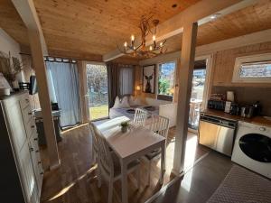 a kitchen and living room with a table and a dining room at Kreischberg Chalet Ferienpark 3 in Sankt Lorenzen ob Murau