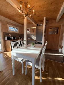 a dining room with a white table and chairs at Kreischberg Chalet Ferienpark 3 in Sankt Lorenzen ob Murau