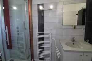 a bathroom with a sink and a shower and a sink at Gîte Chez Reine à ÉtivalClairefontaine Vosges Cal in Étival-Clairefontaine +16 photos