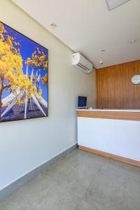 an office with a large painting on the wall at OYO Hotel Brisa Tropical, Brasília in Brasilia
