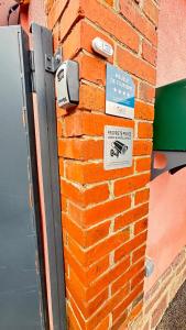 eine Backsteinmauer mit Notfallschildern in der Unterkunft L'instant T 4* Balnéo, Sauna et Parking Privé in Colmar