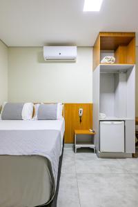 a hotel room with two beds and a kitchen at OYO Hotel Brisa Tropical, Brasília in Brasília