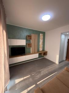 a living room with a flat screen tv on a wall at Appartamenti Rugacesio 24 - B in Pioltello