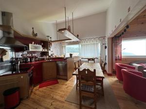 eine Küche und ein Wohnzimmer mit einem Holztisch und einem Esszimmer in der Unterkunft Appartement esprit montagne in Le Lioran