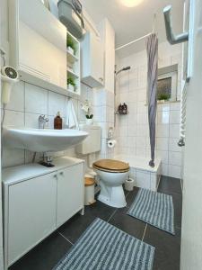 une salle de bain blanche avec un lavabo et des toilettes dans l'établissement Complete All Inclusive Apartment+Netflix, à Wilhelmshaven