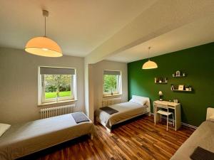 une chambre avec deux lits et un mur végétal dans l'établissement Complete All Inclusive Apartment+Netflix, à Wilhelmshaven