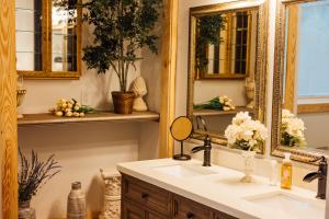 a bathroom with a sink and a mirror at Escape to Villa Serena in Dahlonega