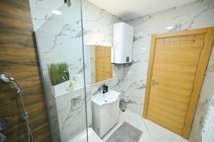 a bathroom with a toilet and a sink and a shower at Monte Royal Zlatibor in Zlatibor +14 photos