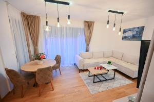 a living room with a couch and a table at Monte Royal Zlatibor in Zlatibor