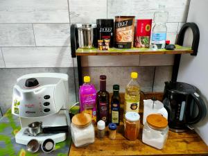 a counter with a coffee maker and bottles of alcohol at casa vacanze Libeccio parcheggio privato in Sapri +19 photos