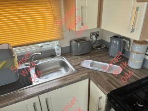 a kitchen with a sink and a counter top at Sunset Walk 046 in Barmouth