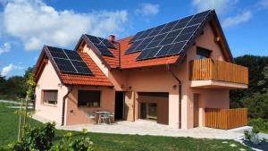 a house with solar panels on the roof at Ana Apartment in Gradišča