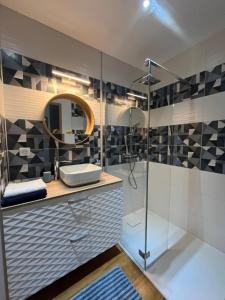 a bathroom with a shower and a sink at Appart' Zen & connect in Ennevelin +44 photos