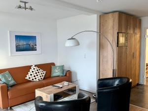 un salon avec un canapé et une table dans l'établissement Küstenliebe, à Heiligenhafen 18 autres photos