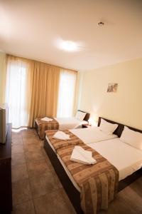 Postel nebo postele na pokoji v ubytování Family hotel Apolon