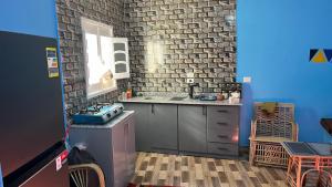 a kitchen with a sink and a brick wall at AnDy Nubian Guest House in Aswan