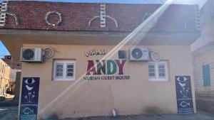 a sign on the side of a building at AnDy Nubian Guest House in Aswan
