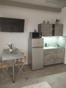 a small kitchen with a table and a microwave at Apartmán u Révy in Bořetice +24 photos