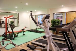 a gym with tread machines and a treadmill at TTC Hotel - Hoi An in Hoi An