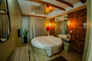 a bedroom with a large bed in a room at Hotel Motel Paradiso - Soledade-RS in Soledade