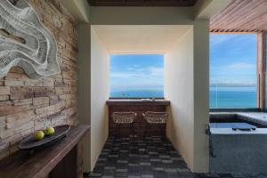 a bathroom with a tub and a view of the ocean at Xi'an seascape meisu-MOMOO Sea in Longgang +119 photos