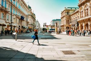 a woman walking down a busy city street at greet Wien City Nord in Vienna