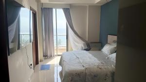 a bedroom with a bed and a large window at Sea View Apartment in Colombo -Dehiwala in Dehiwala +25 photos