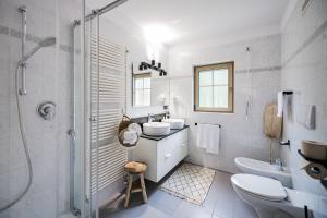 a bathroom with a sink and a toilet and a shower at Boutique Hotel Eggele in San Candido +50 photos