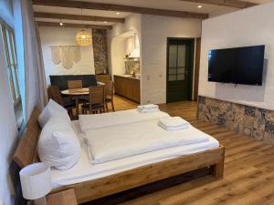 a bedroom with a large bed and a living room at Ferienwohnung am Königssee in Schönau am Königssee