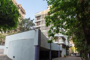 a building with a ramp in front of it at Treat Homes Service Apartment in BKC Siddhant 401 in Mumbai