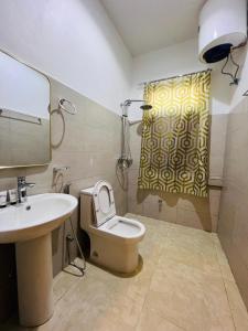 a bathroom with a sink and a toilet and a mirror at Mkunazini Heritage Center in Zanzibar City +58 photos
