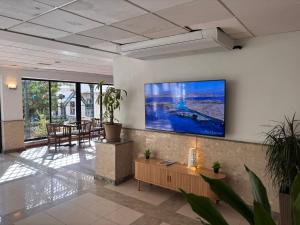 a lobby with a large screen tv on a wall at The San Anton Hotel in St Paul's Bay