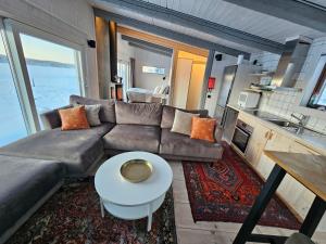 a living room with a couch and a table at Aurora Jukkas Riverside Lodge in Jukkasjärvi